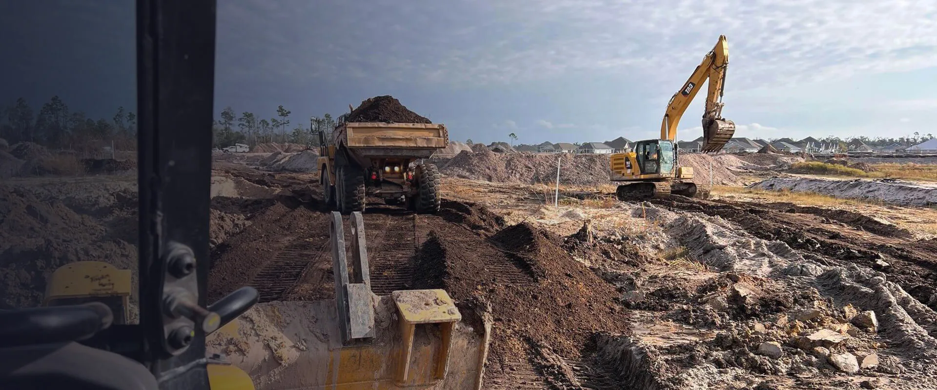 Excavator and dump truck working a site